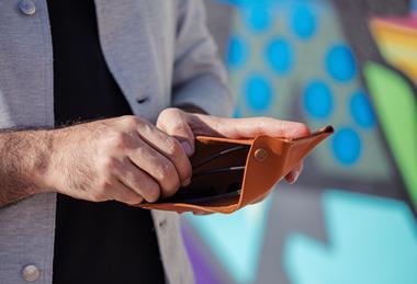 man-taking-money-from-his-wallet